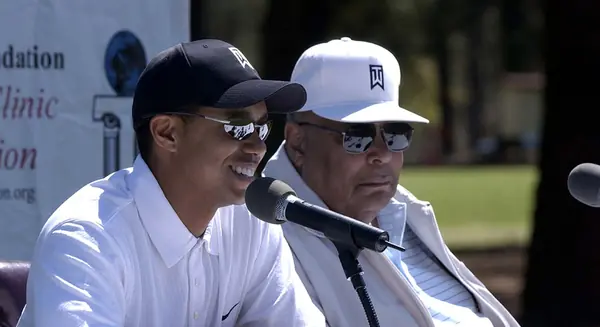 Tiger Woods (left) and his father, Earl Woods, at a press conference after a youth golf clinic, Fort Bragg, April 16, 2004
