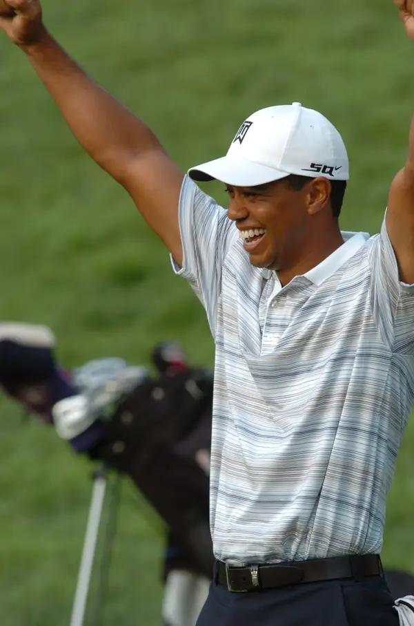 Tiger Woods raising his arms as his honorary caddie holes a birdie putt, pro-am at Congressional, July 4, 2007 (not the 2000 win)